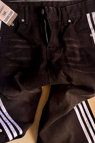 Black jeans with white stripes on the side by SHEIN — pre-loved on Thrifted.mt